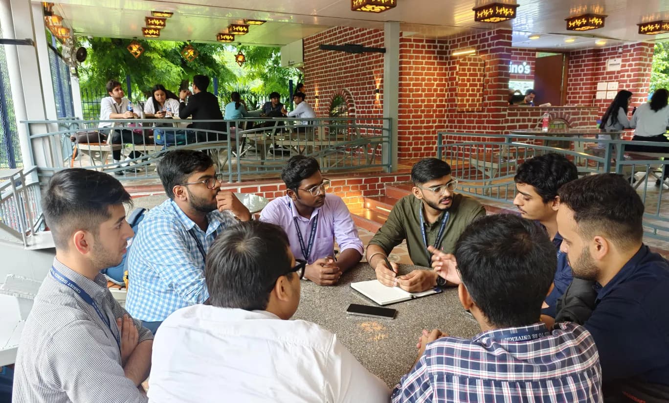 Students discussing plans around a table at a campus café