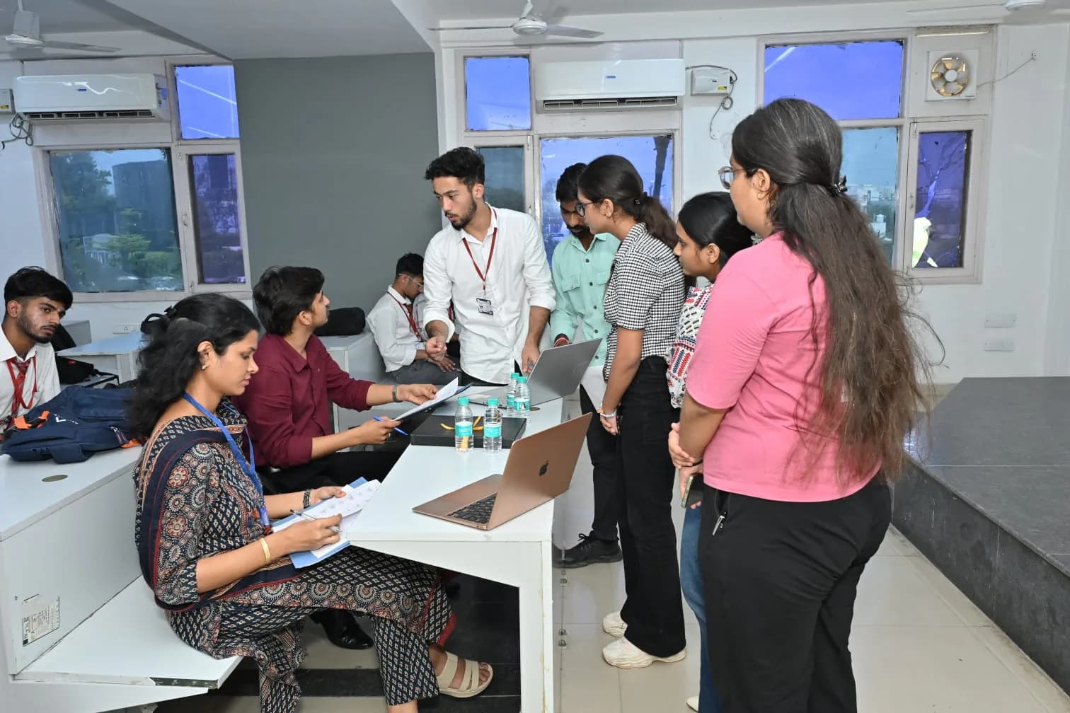 Students and mentors collaborating around a table during a Mentorle workshop